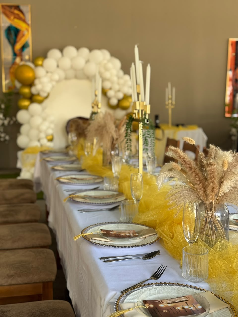 Decorated wedding reception table with white, gold and yellow styling at Monet Guesthouse